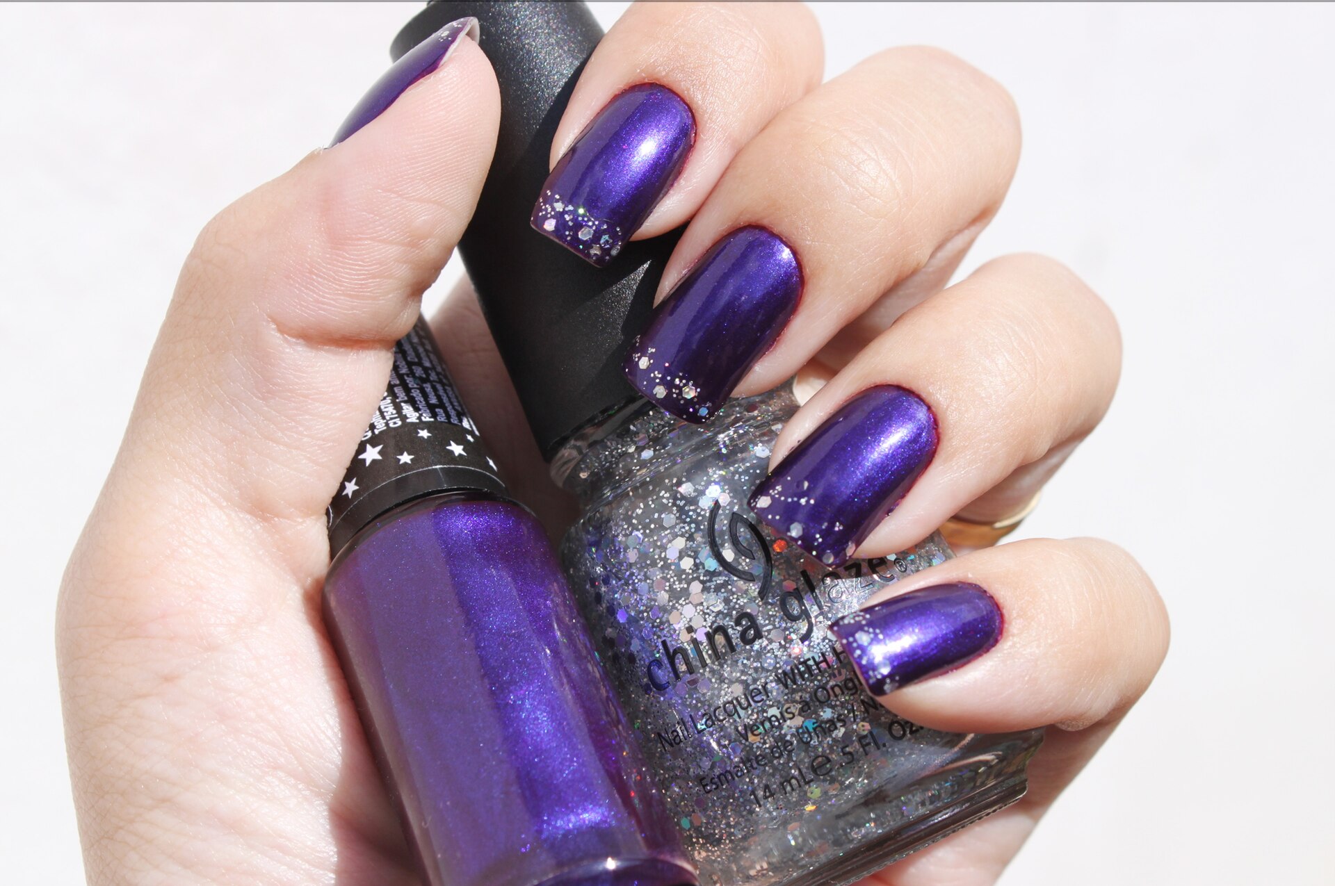 Unghie con smalto viola scuro e glitter